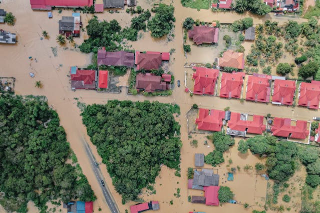 Roofs of residential houses in flooded town-Photo by Pok Rie